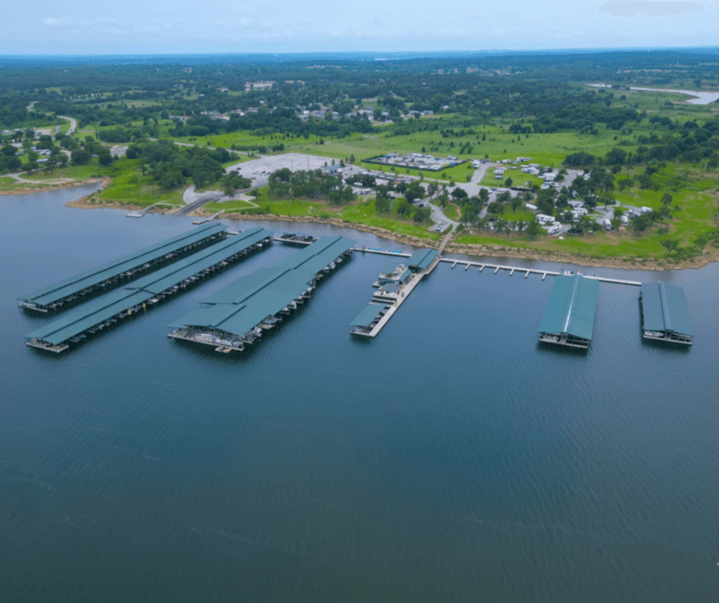Aerial view of G Dock with covered slips and cupola roofs at Keystone Harbor Marina on Lake Keystone, Mannford, Oklahoma