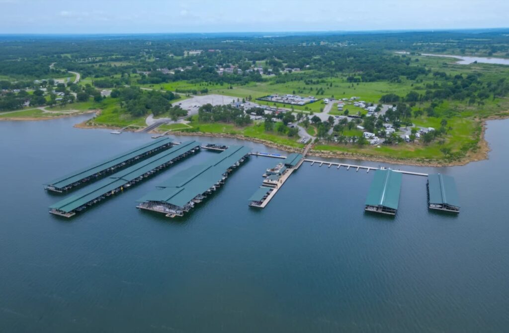 Aerial view of G Dock with covered slips and cupola roofs at Keystone Harbor Marina on Lake Keystone, Mannford, Oklahoma