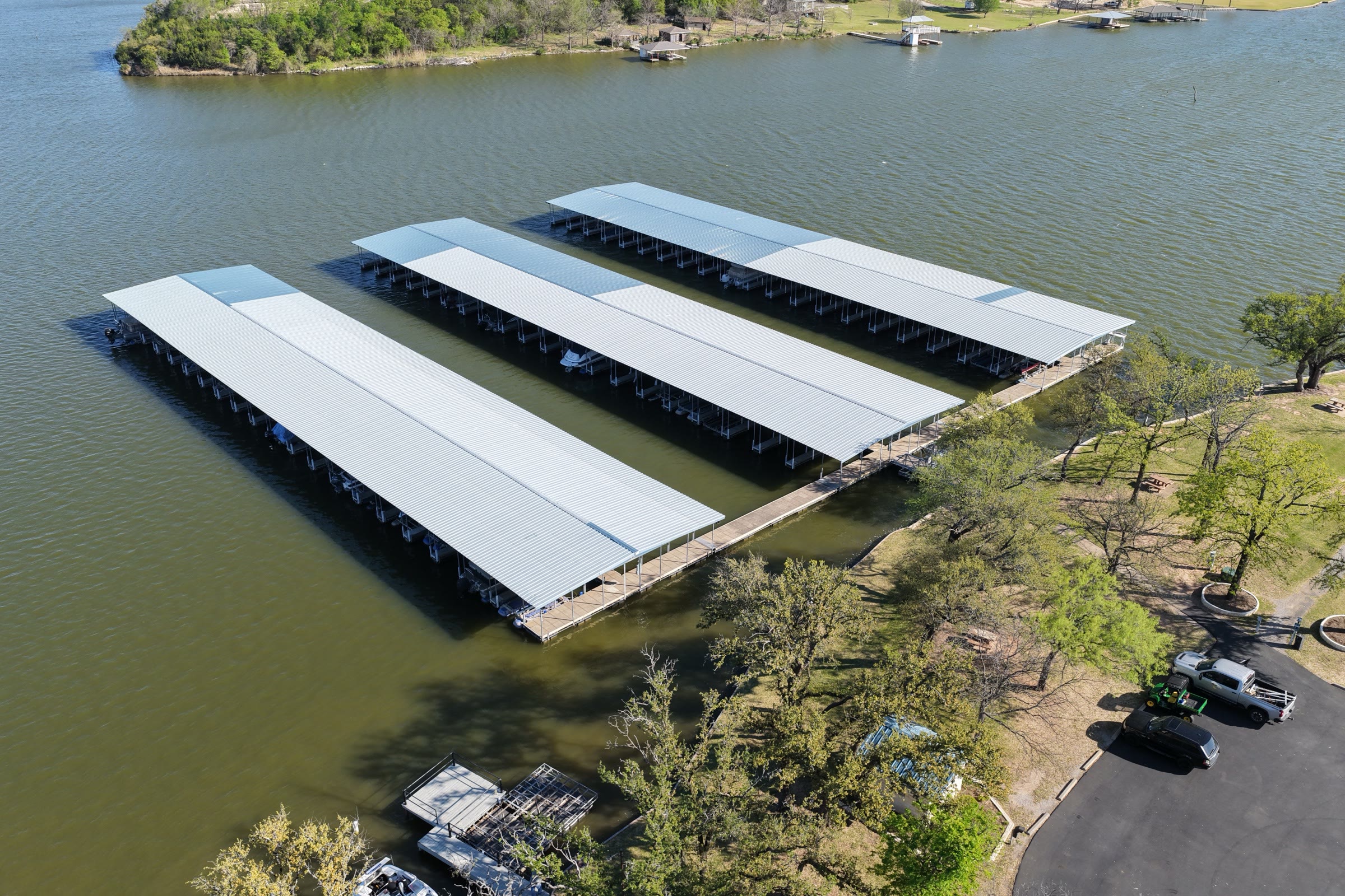 Rebuilt covered boat slips with gable roofs at Mallard Pointe Marina on Lake Granbury, Granbury, Texas