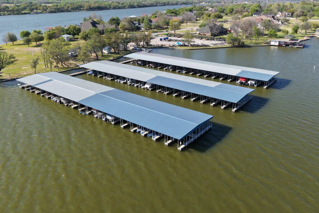 Rebuilt covered boat slips with gable roofs at Mallard Pointe Marina on Lake Granbury, Granbury, Texas