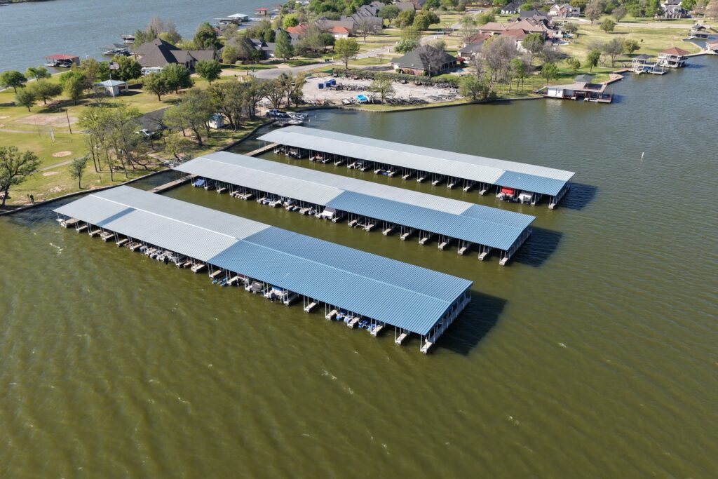 Rebuilt covered boat slips with gable roofs at Mallard Pointe Marina on Lake Granbury, Granbury, Texas