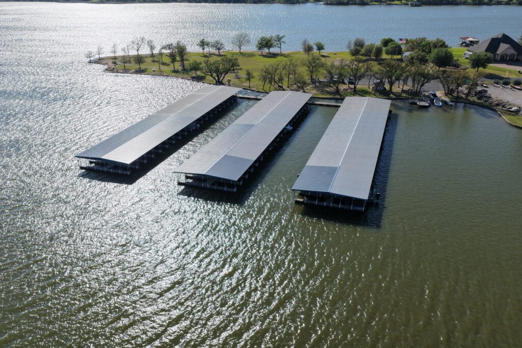 Rebuilt covered boat slips with gable roofs at Mallard Pointe Marina on Lake Granbury, Granbury, Texas