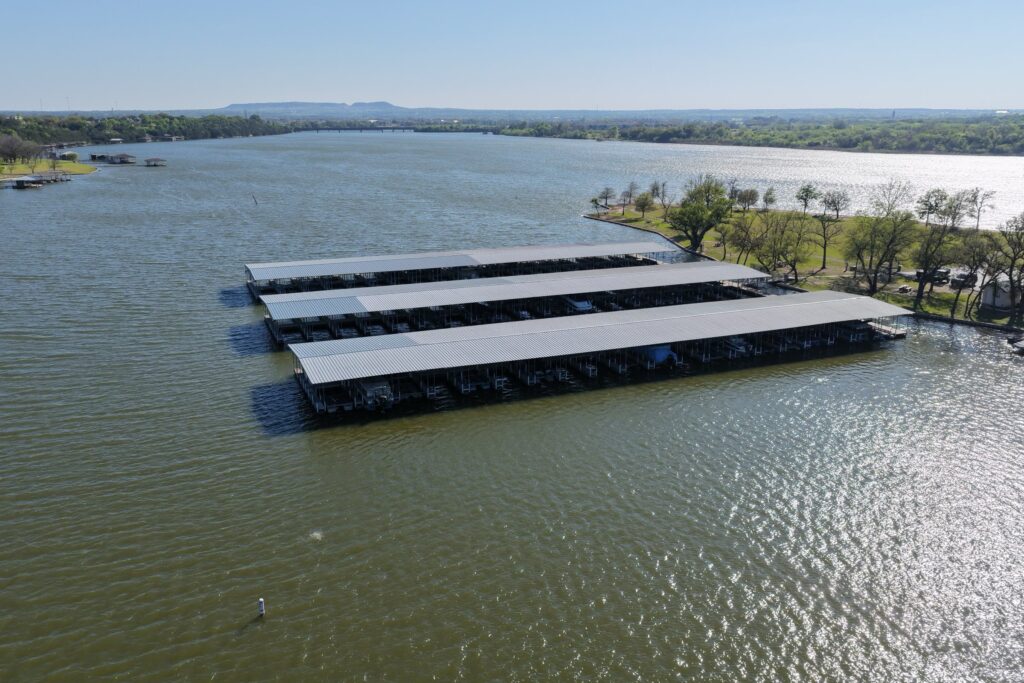 Rebuilt covered boat slips with gable roofs at Mallard Pointe Marina on Lake Granbury, Granbury, Texas