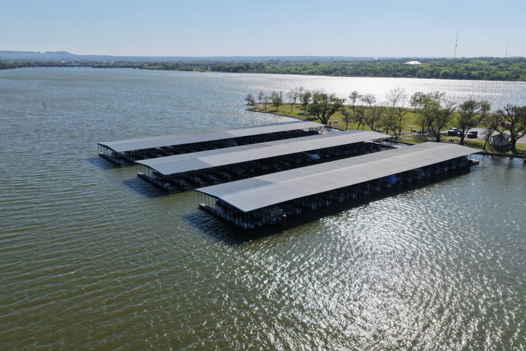Rebuilt covered boat slips with gable roofs at Mallard Pointe Marina on Lake Granbury, Granbury, Texas