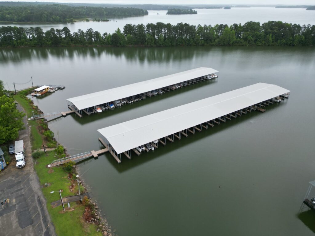 Aerial view of two new covered floating docks with gable roofs at Southern Harbor Marina on West Point Lake, Lanett, Alabama