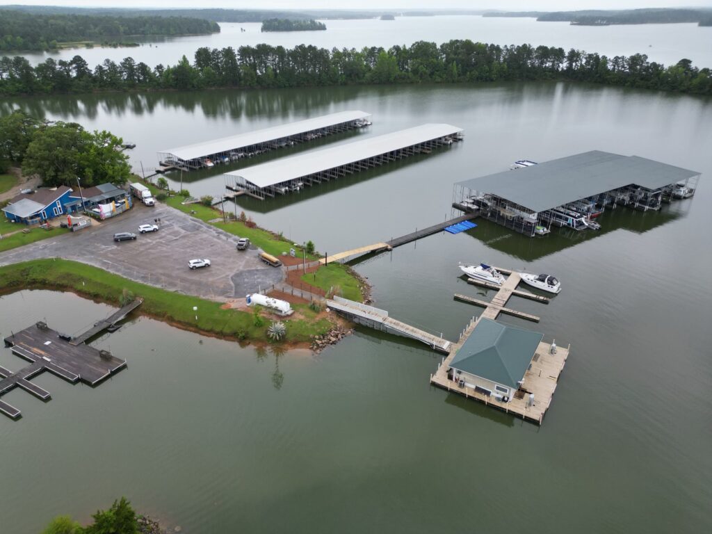 Aerial view of two new covered floating docks with gable roofs at Southern Harbor Marina on West Point Lake, Lanett, Alabama
