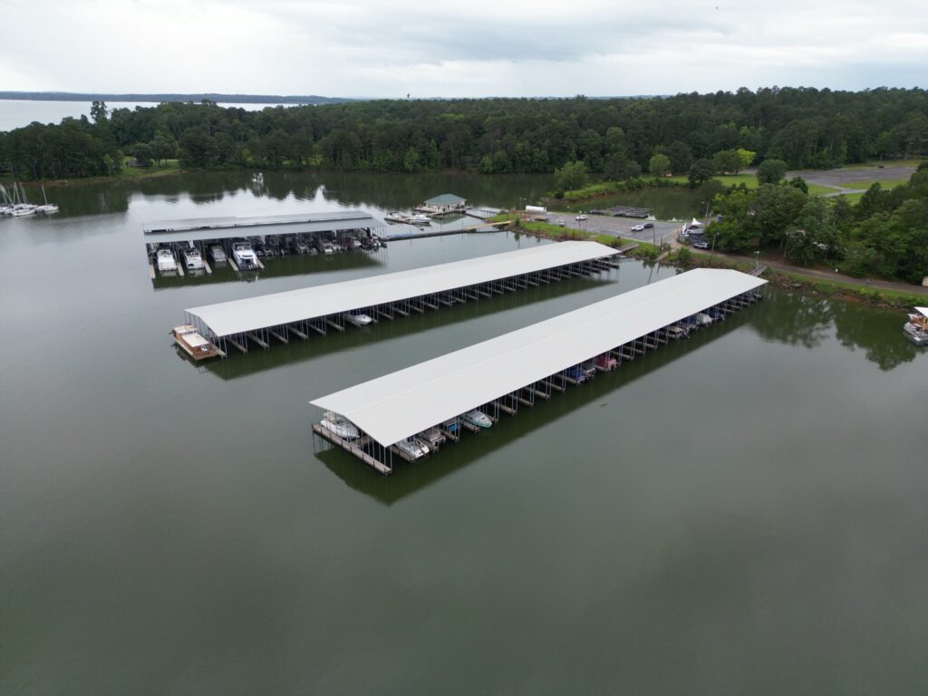 Aerial view of two new covered floating docks with gable roofs at Southern Harbor Marina on West Point Lake, Lanett, Alabama