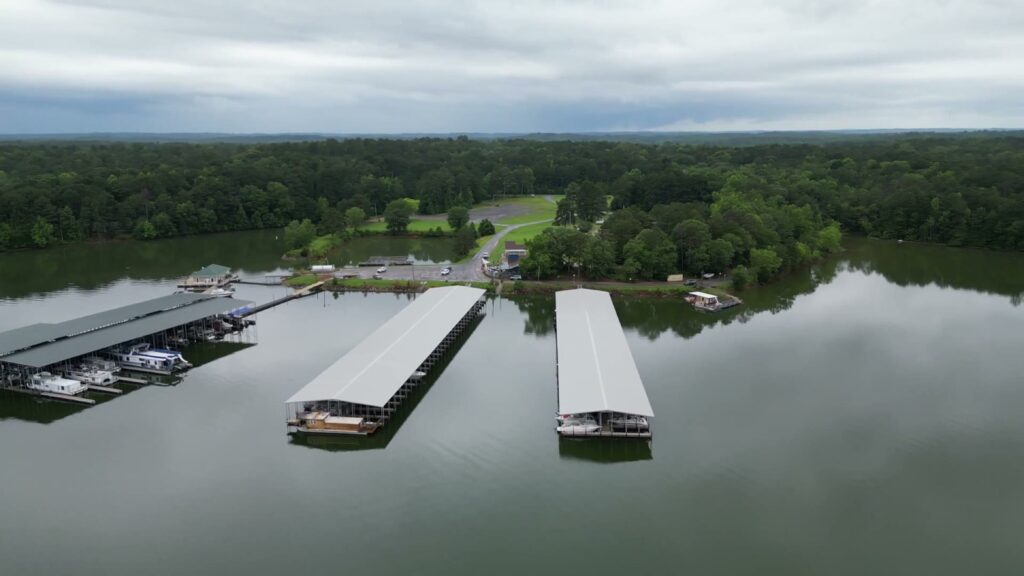 Aerial view of two new covered floating docks with gable roofs at Southern Harbor Marina on West Point Lake, Lanett, Alabama